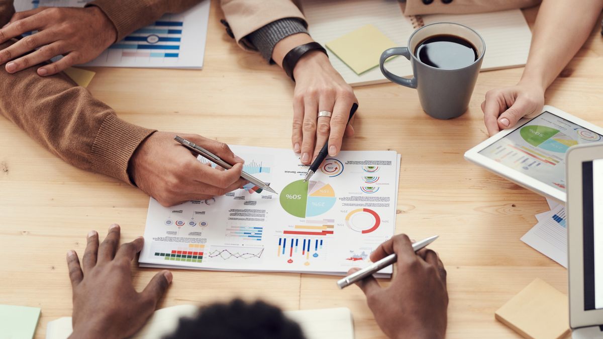 Advisors reviewing investment performance charts and analytics